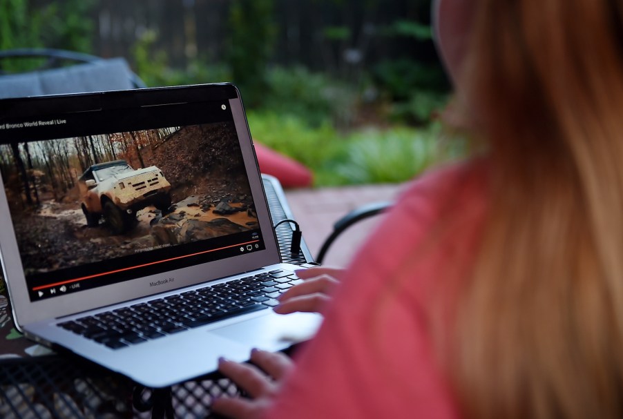 This illustration shows a person watching the 2021 Ford Bronco Family World Premiere on a computer in Arlington, Virginia