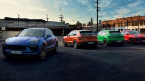 Multiple Porsche Macan small luxury SUVs are parked.