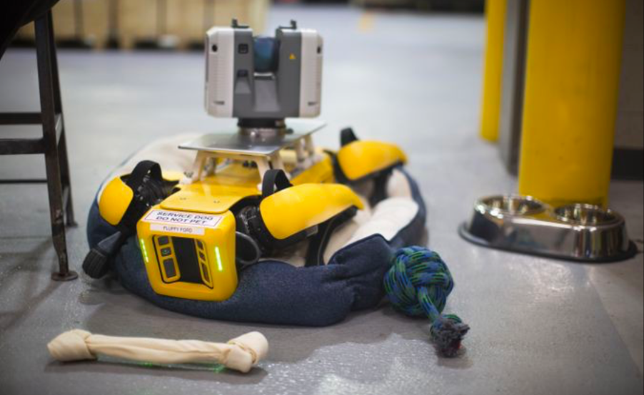 A robot dog recharging in it's bed at the Ford plant