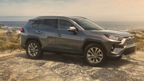 A gray 2019 Toyota RAV4 small SUV is parked off-road.