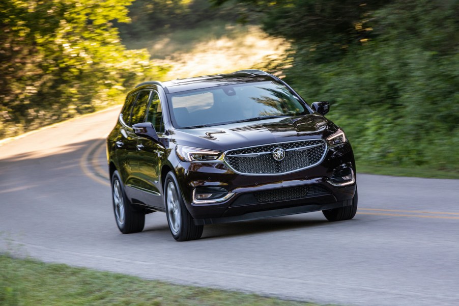 2020 Buick Enclave Avenir driving through a forest