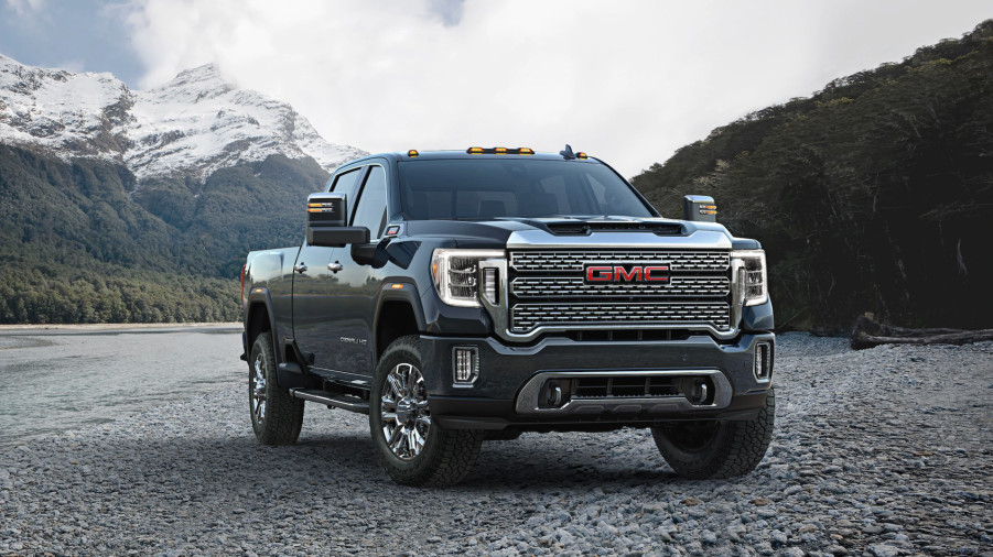 a gray GMC Sierra Denali parked in a gravel yard