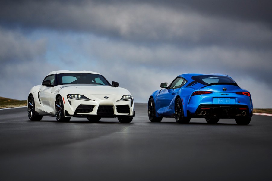 2021 Toyota GR Supra in blue and white parked on a track with overcast skies