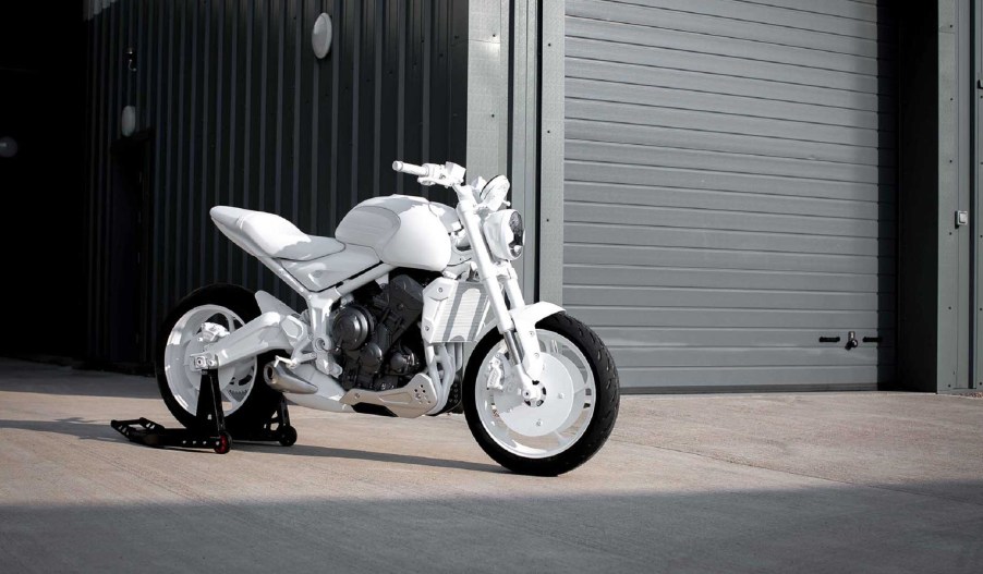 A white 2021 Triumph Trident prototype in front of a garage