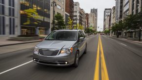 a 2015 silver town and country driving in the city. This is one of the best used minivans to buy.