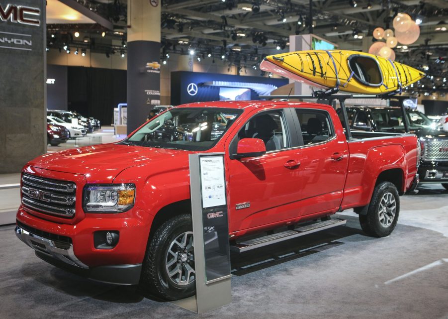 A red GMC Canyon on display at an auto show