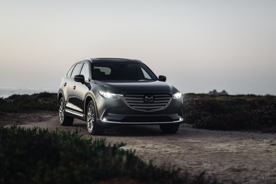 a gray 2020 Mazda CX-9 SUV driving on a gravel road in the countryside