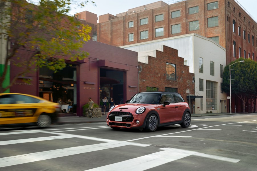 Mini Cooper driving over a crosswalk