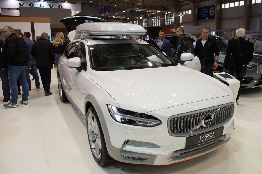 A white Volvo V90 on display at an auto show