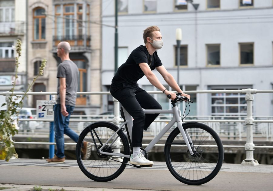 A man rides down the street on an e-bike