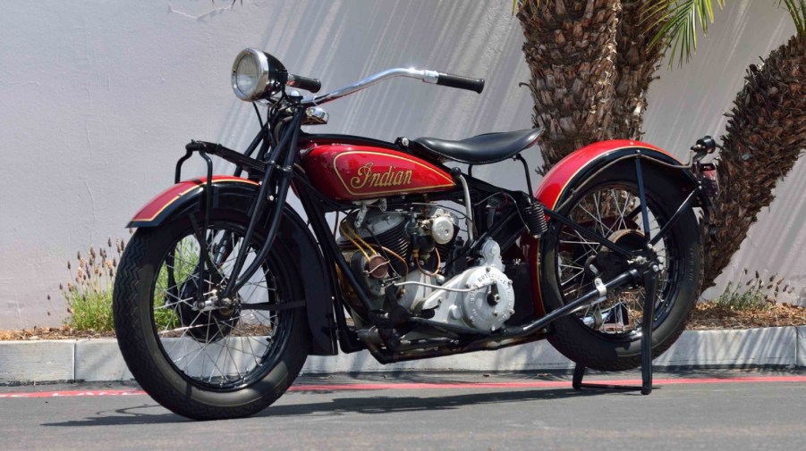 A black-and-red 1929 Indian 101 Scout on its rear-wheel stand