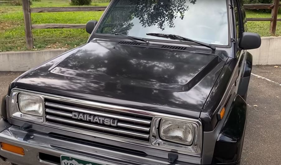 A black 1990 small, tow-door, SUV.