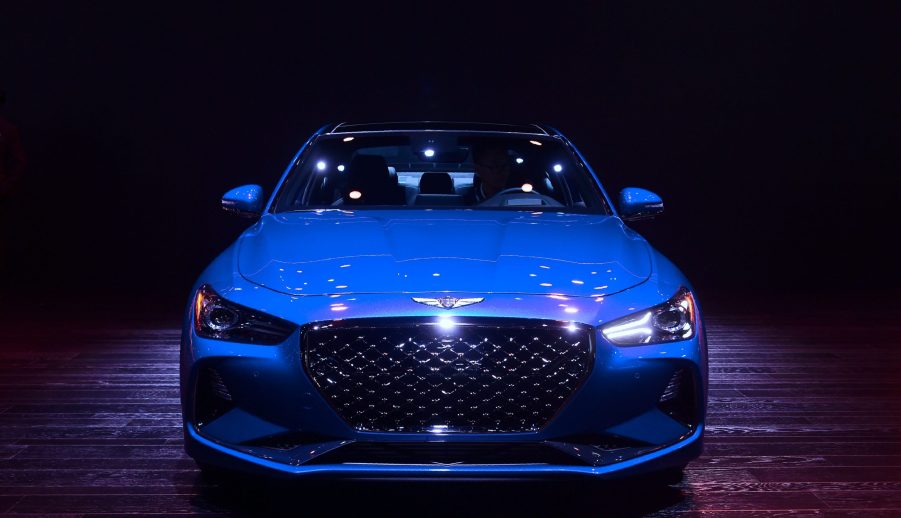 A Genesis G70 on display encased by a shadow