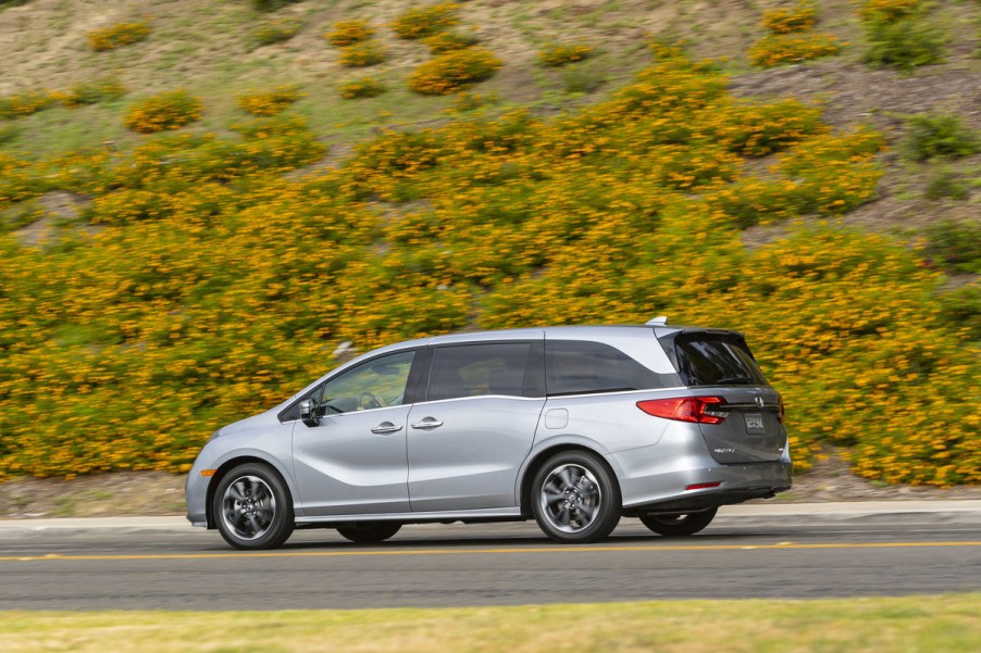 2021 Honda Odyssey driving past yellow flowers in a field