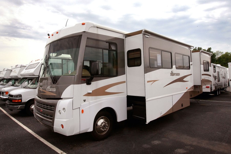 A Winnebago Sightseer motorhome is offered for sale at the Camp-Land RV dealership, which also sells travel trailers