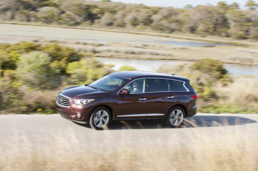 The 2014 Infiniti QX60 driving down a winding road