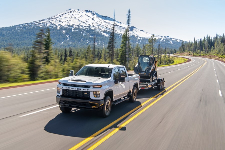 2020 Chevrolet Silverado tows machinery up a mountain road