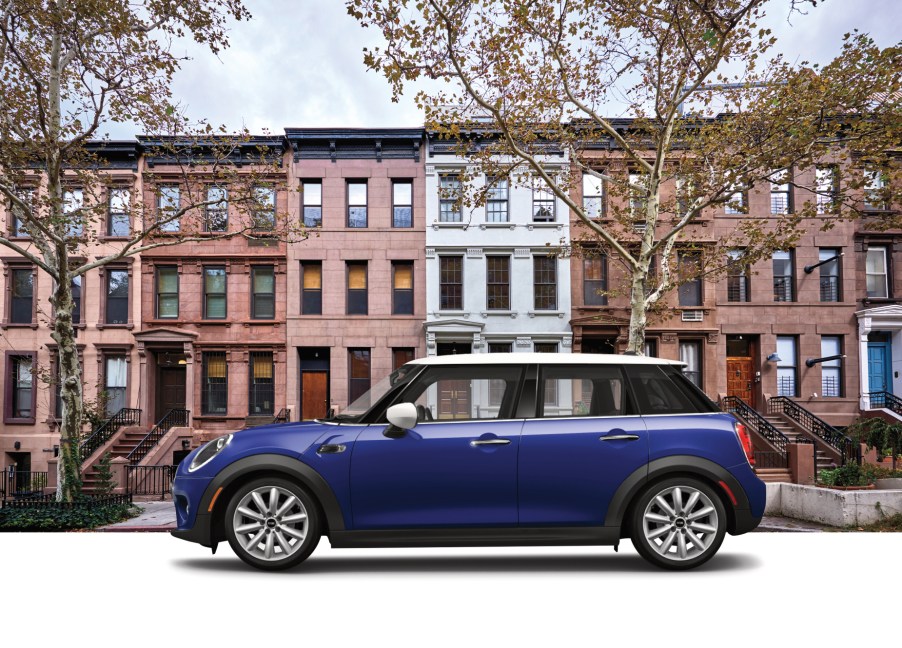 A blue 2020 Mini Cooper Oxford Edition on display in front of a building