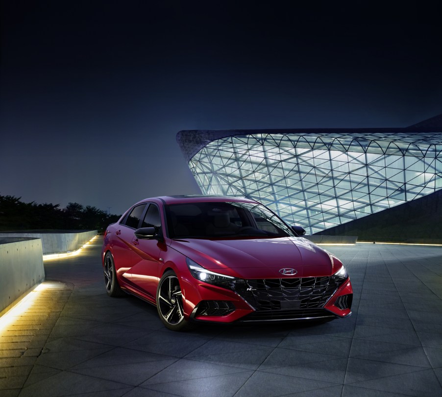 A red 2021 Hyundai Elantra N Line on display in front of a building