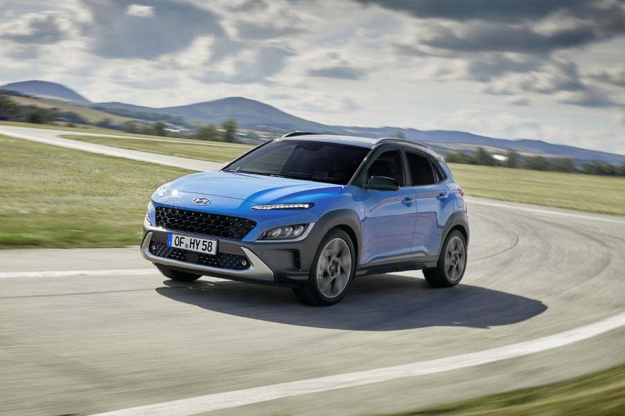 The 2022 Hyundai Kona driving around a curve of a road