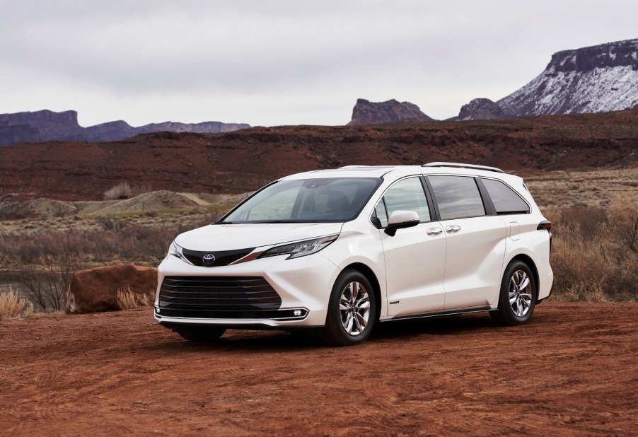 A white 2021 Toyota Sienna on display in a desert terrain