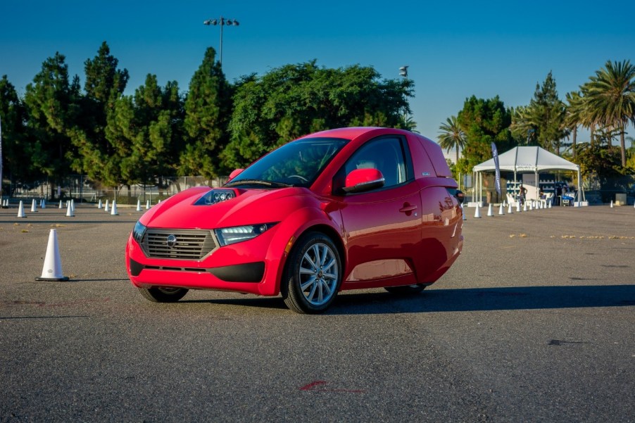 A red Solo, from ElectraMeccanica, sites in a parking lot.