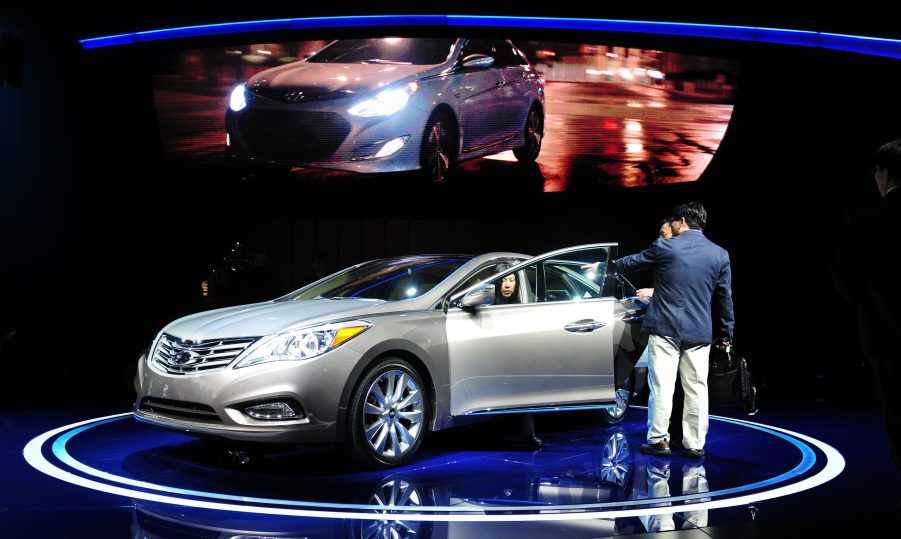 2012 Hyundai Azera parked on a stage with a woman getting out of the driver's seat