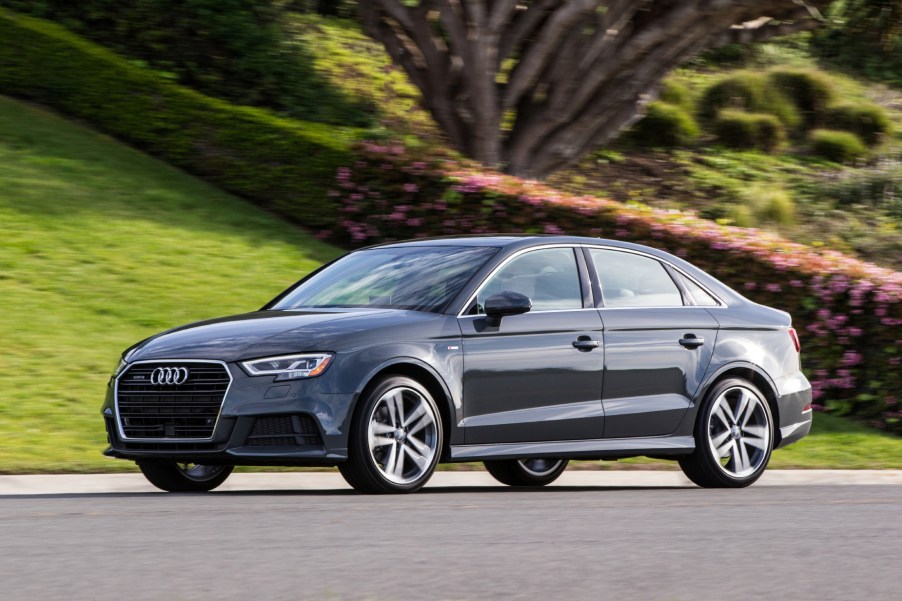 A black 2018 Audi A3 driving down a road