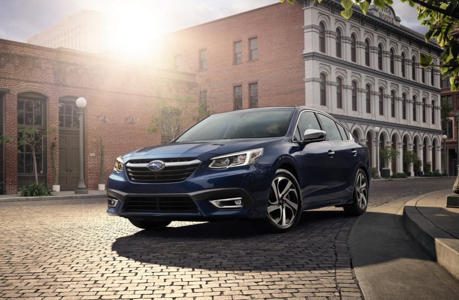 A blue 2021 Subaru Legacy parked in a city