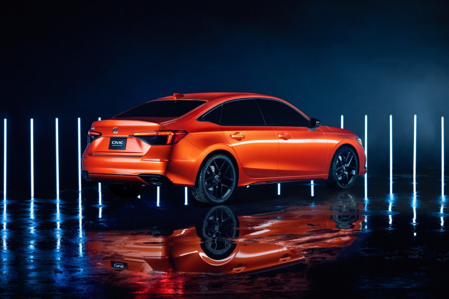 A orange 2022 Honda Civic prototype on display during the car's reveal