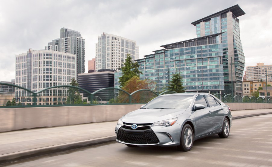 A silver 2017 Toyota Camry Hybrid driving down a highway