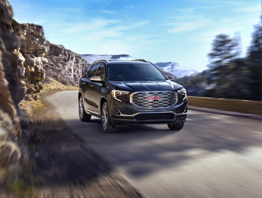 A black 2020 GMC Terrain Denali driving down a road