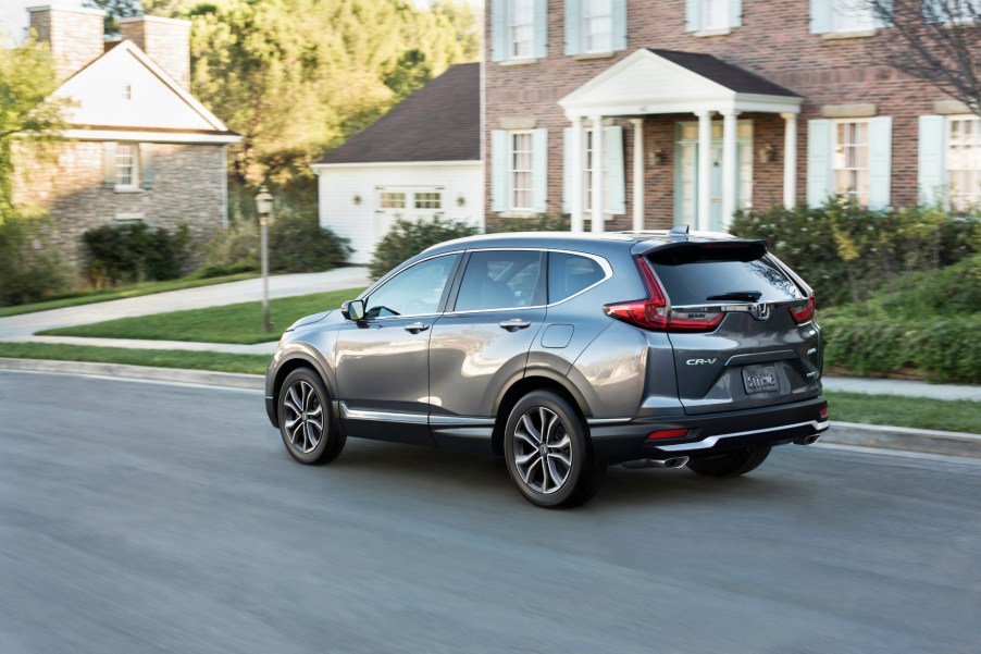 A grey 2021 Honda CR-V driving down a road