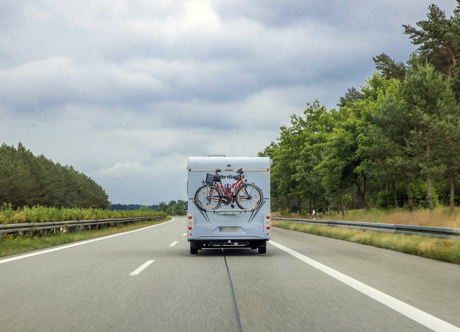 An RV driving down a scenic road