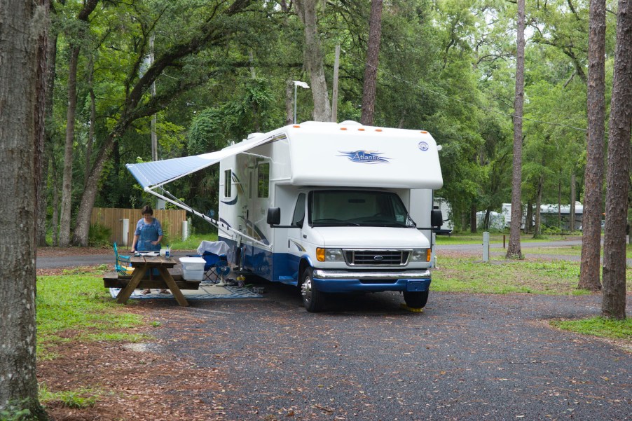 Woman preparing meal outside motorhome