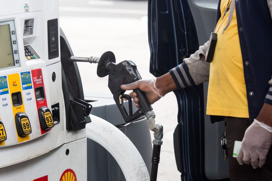 A person grabs a pump nozzle at a Shell gas station in Brooklyn on April 9, 2020.