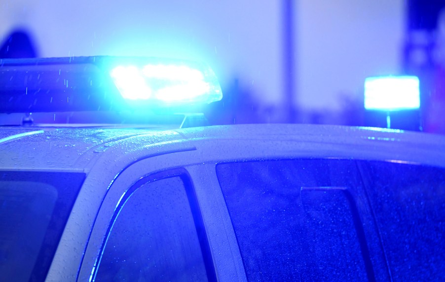 Flashing blue lights on top of a police car