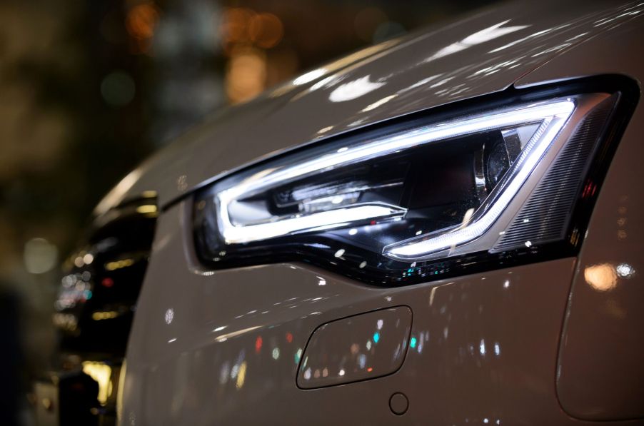 A close-up of a white 2015 Audi A5 Cabriolet's LED headlight