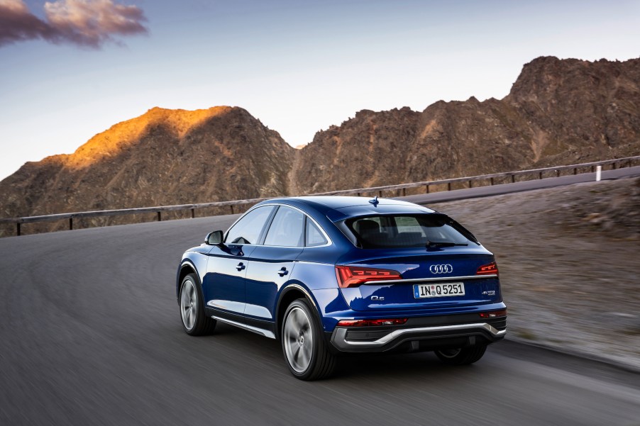 A 2021 Audi Q5 Sportback in Ultra Blue (European model) traveling around a curve on a mountain road