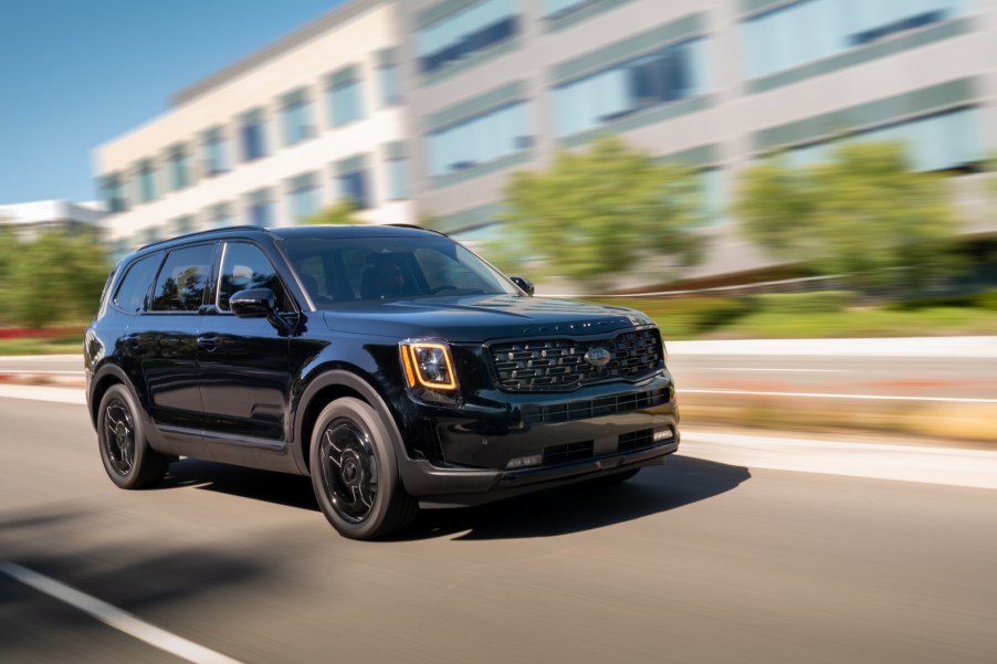 A black 2021 Kia Telluride Nightfall Edition driving down a city road