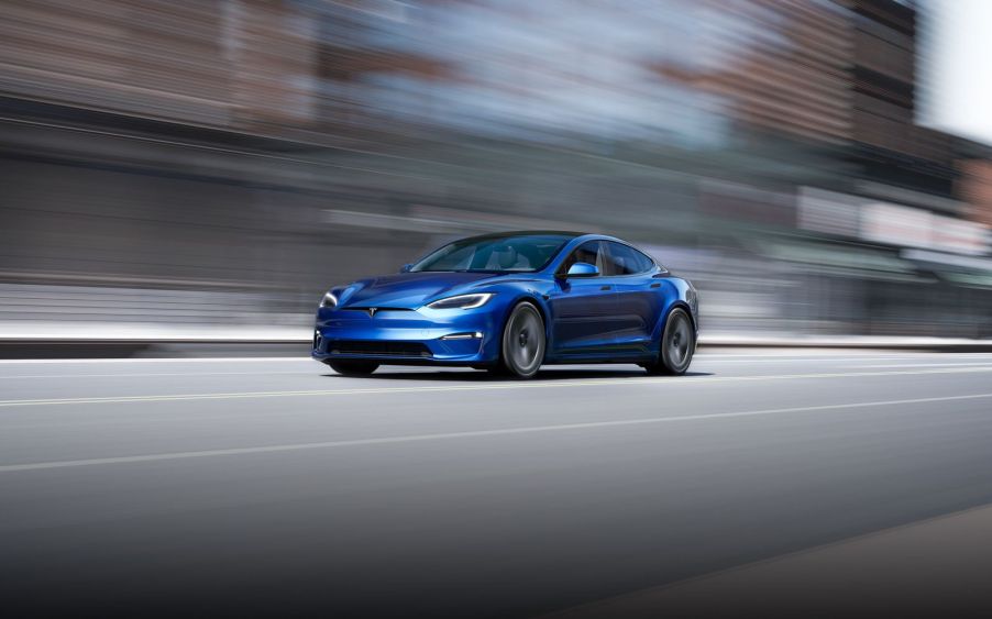 A refreshed blue 2021 Tesla Model S driving down the street.