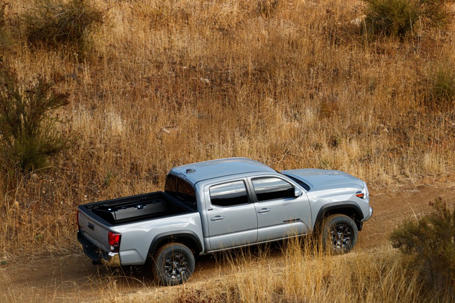 A silver 2021 Toyota Tacoma driving off-road