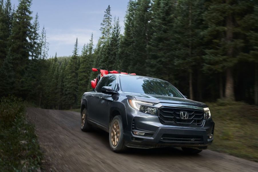 a honda ridgeline at speed on a dirt road