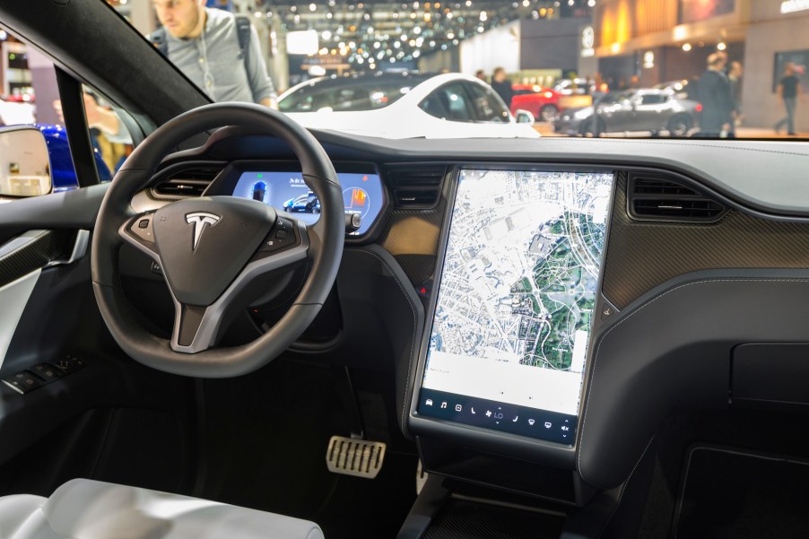 An image of a Tesla infotainment screen at an auto show.