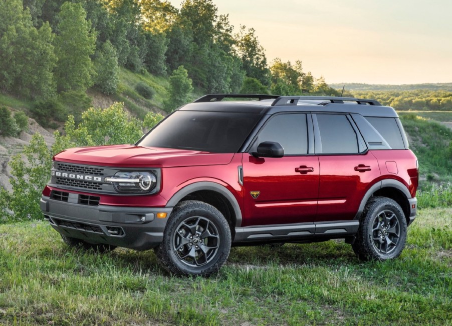 The side 3/4 view of a red 2021 Ford Bronco Sport Badlands in a grassy field