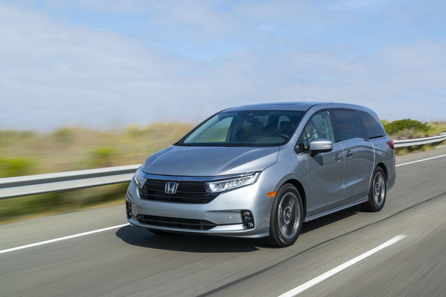 The 2021 Honda Odyssey driving down an empty road