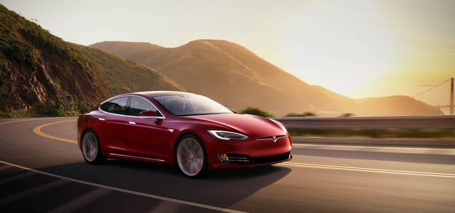 2021 Tesla Model S driving during sunset