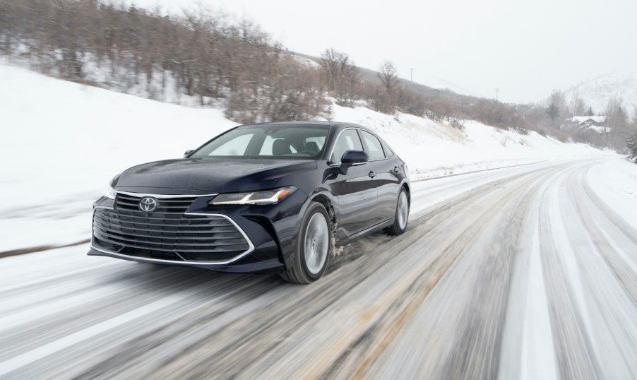 The 2021 Toyota Avalon driving down a snow covered road