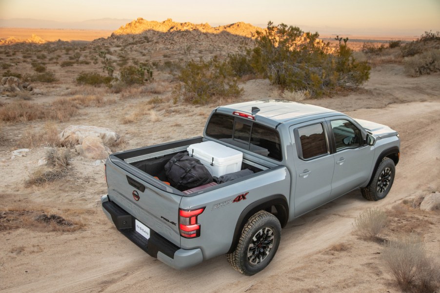 an elevated view of a loaded 2022 Nissan Frontier truck bed as it drives off-road through the desert