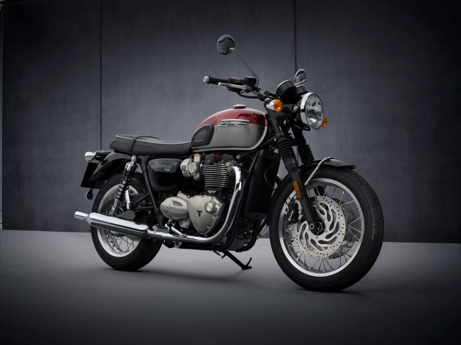 A red-and-silver 2022 Triumph Bonneville T120 in front of a gray background